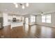 Open living and kitchen area with hardwood floors, central island, stainless appliances and large windows at 6830 Park Grove Blvd, Whitestown, IN 46075