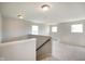 Upstairs loft area featuring neutral carpet, white walls, and natural light from three windows at 6830 Park Grove Blvd, Whitestown, IN 46075