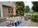 Outdoor patio with dining area, fire pit, and lush landscaping perfect for entertaining at 6862 Riverside Way, Fishers, IN 46038