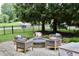 Relaxing backyard patio with a stone fire pit and comfortable seating area at 6862 Riverside Way, Fishers, IN 46038