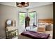 A cozy bedroom with two windows, a wooden bed frame and stylish vanity and mirror set at 6862 Riverside Way, Fishers, IN 46038