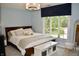 Bright bedroom featuring large window, storage bench, and plush decor at 6862 Riverside Way, Fishers, IN 46038