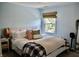 A comfortably decorated bedroom with a plush bed and a window providing natural light at 6862 Riverside Way, Fishers, IN 46038