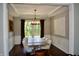 Dining room with a chandelier, wainscotting and a table with six chairs at 6862 Riverside Way, Fishers, IN 46038