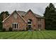 Lovely brick home featuring a manicured front lawn and arched entryway at 6862 Riverside Way, Fishers, IN 46038