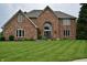 Charming two-story brick home with a well-manicured lawn and beautiful landscaping at 6862 Riverside Way, Fishers, IN 46038