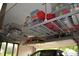 Garage featuring overhead storage racks and an open garage door at 6862 Riverside Way, Fishers, IN 46038