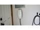 Electric car charger is mounted on the wall inside the garage at 6862 Riverside Way, Fishers, IN 46038