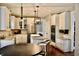 Bright kitchen features stainless appliances, granite counters, hardwood floors, and center island with bar stool seating at 6862 Riverside Way, Fishers, IN 46038