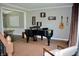 Sitting area with a piano, wood floors and neutral walls at 6862 Riverside Way, Fishers, IN 46038