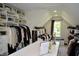Large walk-in closet with custom shelving for organizing clothes, shoes and accessories at 6862 Riverside Way, Fishers, IN 46038