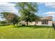 Wide backyard featuring a grassy lawn, mature trees, a fence, and exterior of the home at 69 Stoneybrook Dr, Greenwood, IN 46142