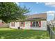 Exterior view of the home's siding, windows with red shutters, grassy lawn, and black fence at 69 Stoneybrook Dr, Greenwood, IN 46142
