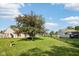 Expansive backyard with lush green lawn, mature shade trees, and a secure chain-link fence at 69 Stoneybrook Dr, Greenwood, IN 46142