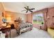 Bedroom with floral wallpaper, ceiling fan, and a window overlooking the backyard at 69 Stoneybrook Dr, Greenwood, IN 46142