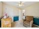 Cozy bedroom with a comfortable chair, dresser, and view to the rest of the home at 69 Stoneybrook Dr, Greenwood, IN 46142