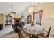 Cozy dining area featuring vaulted ceilings, a decorative chandelier, and a charming lace tablecloth at 69 Stoneybrook Dr, Greenwood, IN 46142