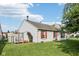 Exterior view showing a quaint backyard, red shutters, deck with pergola and tidy lawn at 69 Stoneybrook Dr, Greenwood, IN 46142