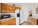 Functional kitchen with ample cabinet space, a white refrigerator, and easy access to the living area at 69 Stoneybrook Dr, Greenwood, IN 46142