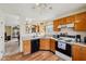 Well-maintained kitchen with wood cabinets, essential appliances, and a view to the dining area at 69 Stoneybrook Dr, Greenwood, IN 46142