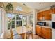 Cozy kitchen nook with a wooden table, window with curtains, and plenty of natural light at 69 Stoneybrook Dr, Greenwood, IN 46142