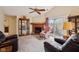 Inviting living room with a brick fireplace, display cabinet, and access to the outdoor patio at 69 Stoneybrook Dr, Greenwood, IN 46142