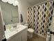 A bathroom features a shower/tub, toilet, and a sink with a mirror at 7022 Cordova Dr, Indianapolis, IN 46221