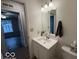 A bathroom with a toilet, sink, and a view to the adjacent room at 7022 Cordova Dr, Indianapolis, IN 46221