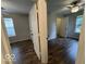 A bedroom features wood flooring, two windows, and a ceiling fan at 7022 Cordova Dr, Indianapolis, IN 46221