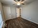 A bedroom features wood flooring, a ceiling fan, and a view to another room at 7022 Cordova Dr, Indianapolis, IN 46221