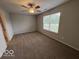 Spacious bedroom featuring neutral carpet, a ceiling fan, and natural light from a large window at 7022 Cordova Dr, Indianapolis, IN 46221