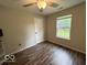 A bedroom with wood flooring and a ceiling fan at 7022 Cordova Dr, Indianapolis, IN 46221