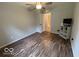 This bedroom features wood floors, a ceiling fan and a door to the bathroom at 7022 Cordova Dr, Indianapolis, IN 46221