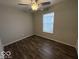 A bedroom with a window, ceiling fan, and wood flooring at 7022 Cordova Dr, Indianapolis, IN 46221