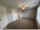 Bright bedroom with neutral walls, a ceiling fan, and a glimpse into an en-suite bathroom at 7022 Cordova Dr, Indianapolis, IN 46221