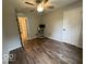 A bedroom featuring wood flooring, a window, and a ceiling fan at 7022 Cordova Dr, Indianapolis, IN 46221