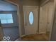 Bright foyer with tile flooring, and a view into the living area of the home at 7022 Cordova Dr, Indianapolis, IN 46221