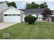 Charming home featuring a two-car garage, well-kept lawn, and inviting curb appeal at 7022 Cordova Dr, Indianapolis, IN 46221
