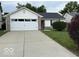 Charming home featuring a two-car garage, well-kept lawn, and inviting curb appeal at 7022 Cordova Dr, Indianapolis, IN 46221