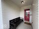 Cozy front porch with a bench, perfect for enjoying the outdoors, and a welcoming red door at 7022 Cordova Dr, Indianapolis, IN 46221
