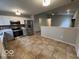 Open concept kitchen with stainless steel appliances that transitions into the living room at 7022 Cordova Dr, Indianapolis, IN 46221