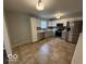 Bright kitchen featuring updated cabinets, stainless steel appliances, and durable tile flooring at 7022 Cordova Dr, Indianapolis, IN 46221