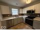 Updated kitchen featuring stainless steel appliances, modern backsplash, and ample counter space at 7022 Cordova Dr, Indianapolis, IN 46221