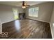 Bright living room with wood-look flooring and large windows for natural light, and a door to the backyard at 7022 Cordova Dr, Indianapolis, IN 46221