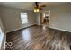 Living room with wood-look floors and a view to the kitchen with stainless steel appliances at 7022 Cordova Dr, Indianapolis, IN 46221