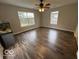 Bright living room with wood-look flooring and large windows that let in plenty of natural light at 7022 Cordova Dr, Indianapolis, IN 46221