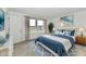 Comfortable bedroom with a soft white bed, blue accents, and light wood nightstands at 7147 Buckley Branch Dr, Indianapolis, IN 46259