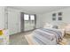Bright bedroom with a white bed, neutral gray bedding, and matching white nightstands at 7147 Buckley Branch Dr, Indianapolis, IN 46259