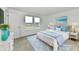 Bright bedroom with a white bed, blue accents, and matching white nightstands at 7147 Buckley Branch Dr, Indianapolis, IN 46259
