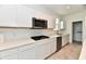 Modern kitchen with white cabinets, stainless steel appliances, and quartz countertops at 7147 Buckley Branch Dr, Indianapolis, IN 46259